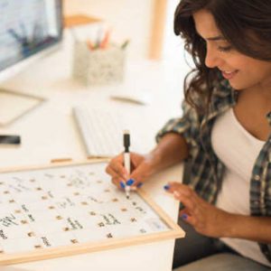 woman writing in her calendar