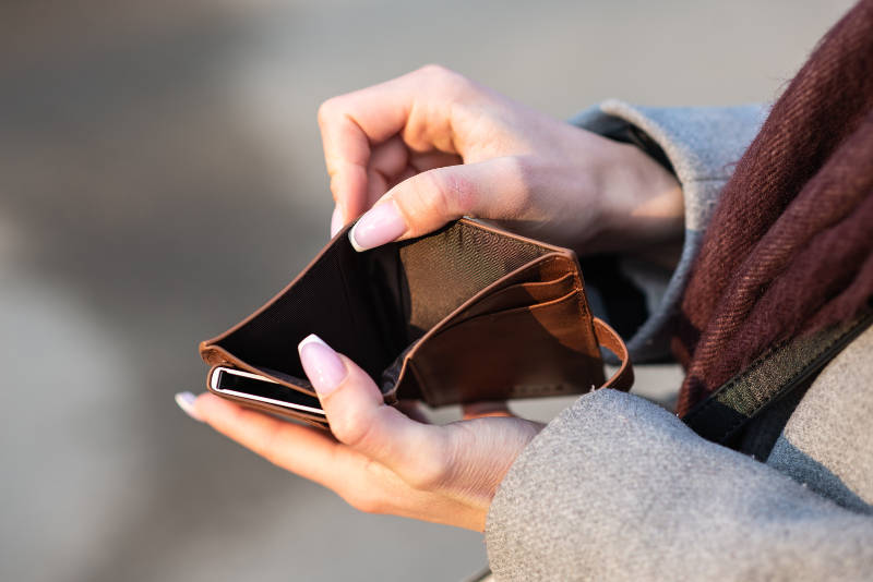 female hands holding an empty wallet
