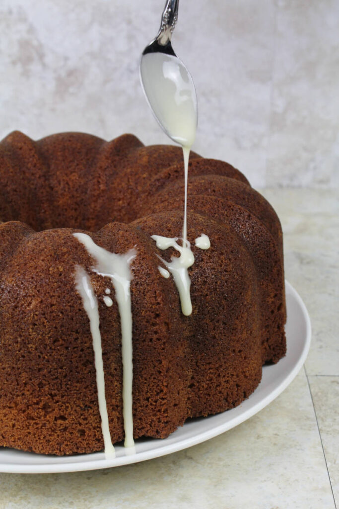 drizzling glaze on the cake