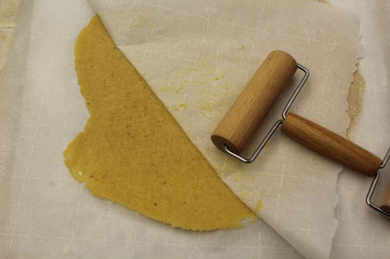crust for keto pumpkin pie rolled out between parchment paper