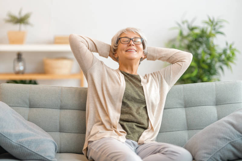 mature woman smiling and daydreaming